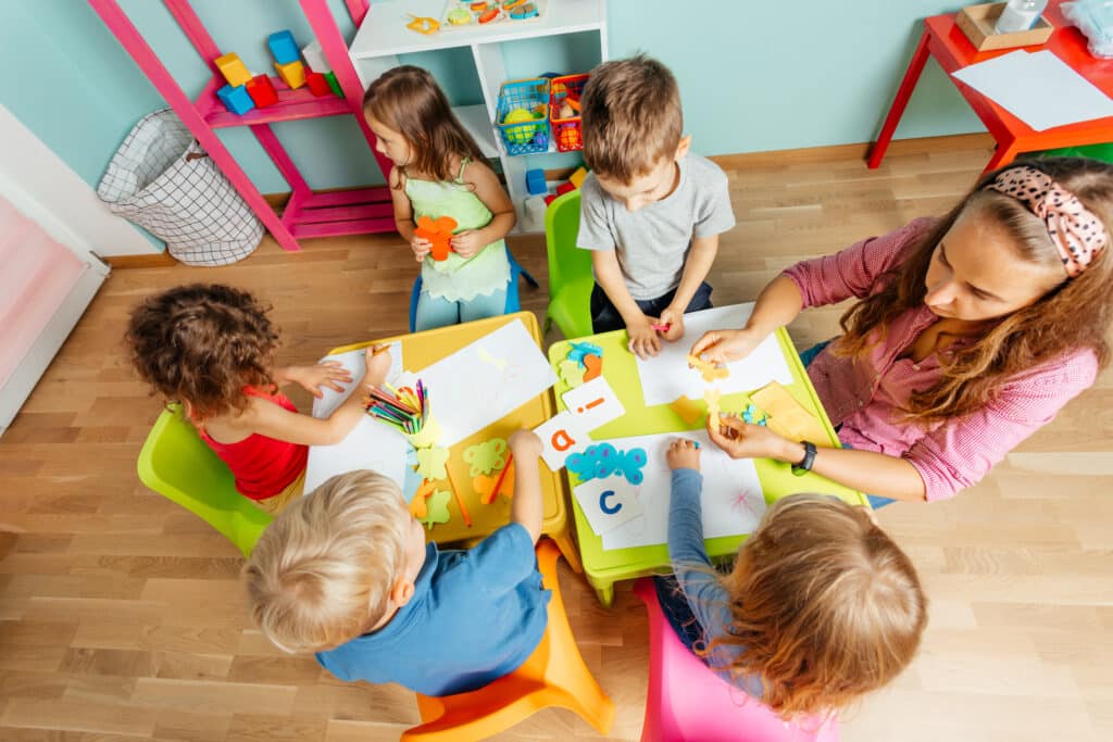 Happy Little Girl Showing Her Drawing To The Camera